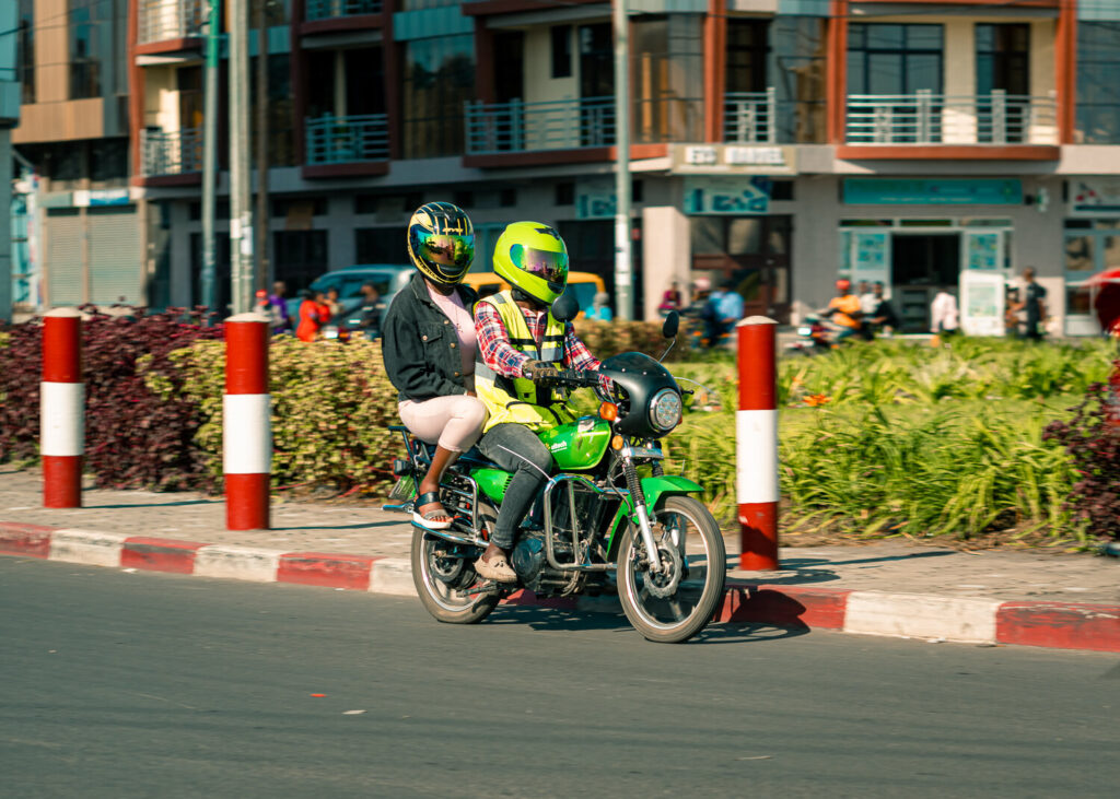 A female customer using an e-motorcycle taxi in the Democratic Republic of the Congo