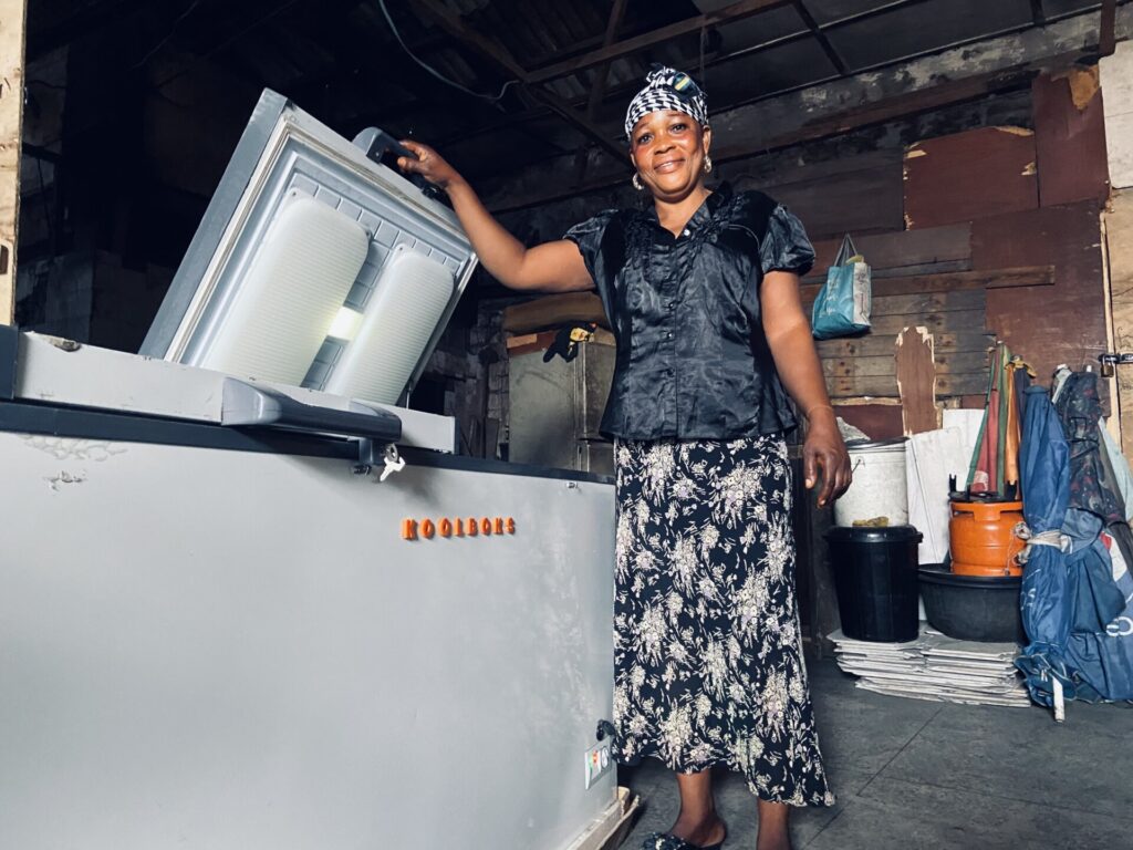 Female customer using a Koolboks freezer – Koolboks